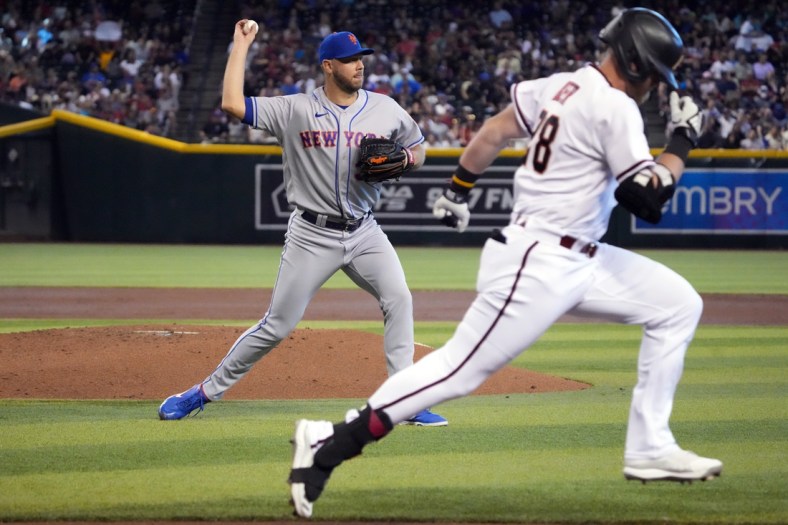 Apr 24, 2022; Phoenix, Arizona, USA; New York Mets starting pitcher Tylor Megill (38) throws out Arizona Diamondbacks designated hitter Seth Beer (28) at first base during the second inning at Chase Field. Mandatory Credit: Joe Camporeale-USA TODAY Sports