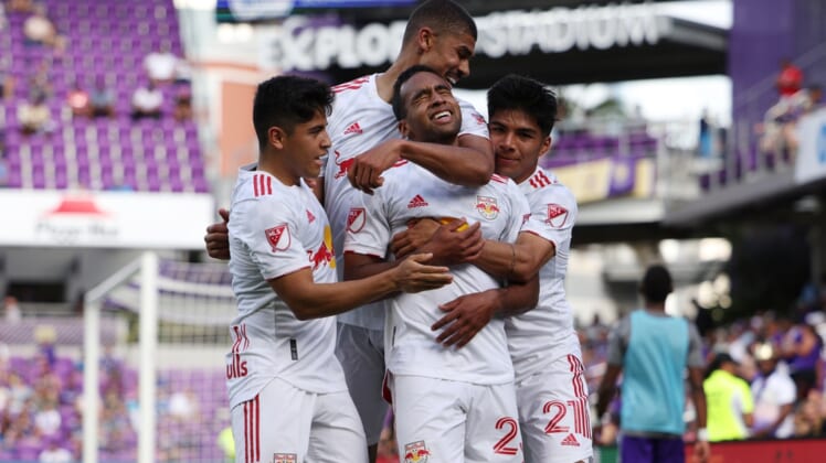 Apr 24, 2022; Orlando, Florida, USA; New York Red Bulls midfielder Cristian Casseres Jr (23) celebrates scoring a goal with teammates in the second half against the Orlando City at Exploria Stadium. Mandatory Credit: Nathan Ray Seebeck-USA TODAY Sports