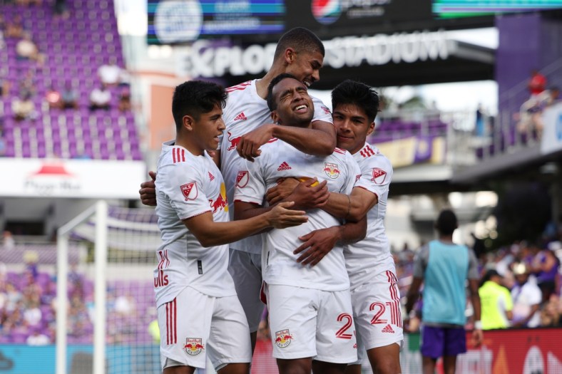 Apr 24, 2022; Orlando, Florida, USA; New York Red Bulls midfielder Cristian Casseres Jr (23) celebrates scoring a goal with teammates in the second half against the Orlando City at Exploria Stadium. Mandatory Credit: Nathan Ray Seebeck-USA TODAY Sports