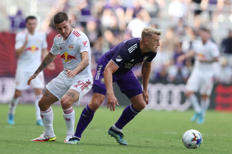 Apr 24, 2022; Orlando, Florida, USA; Orlando City defender Robin Jansson (6) looks to move the ball defended by New York Red Bulls forward Patryk Klimala (9) in the second half at Exploria Stadium. Mandatory Credit: Nathan Ray Seebeck-USA TODAY Sports
