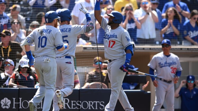 Apr 24, 2022; San Diego, California, USA; Los Angeles Dodgers center fielder Cody Bellinger (second from left) celebrates with second baseman Hanser Alberto (17) after hitting a three-run home run against the San Diego Padres during the fifth inning at Petco Park. Mandatory Credit: Orlando Ramirez-USA TODAY Sports