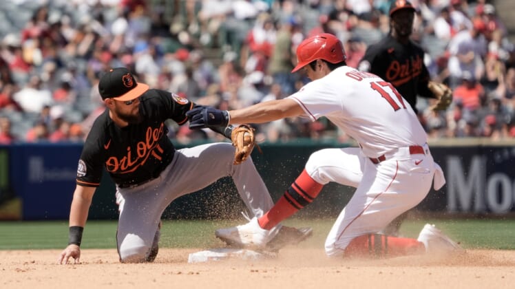 Apr 24, 2022; Anaheim, California, USA; Los Angeles Angels designated hitter Shohei Ohtani (17) is tagged out at second base by Baltimore Orioles second baseman Chris Owings (11) on a stolen base attempt in the fourth inning at Angel Stadium. Mandatory Credit: Kirby Lee-USA TODAY Sports