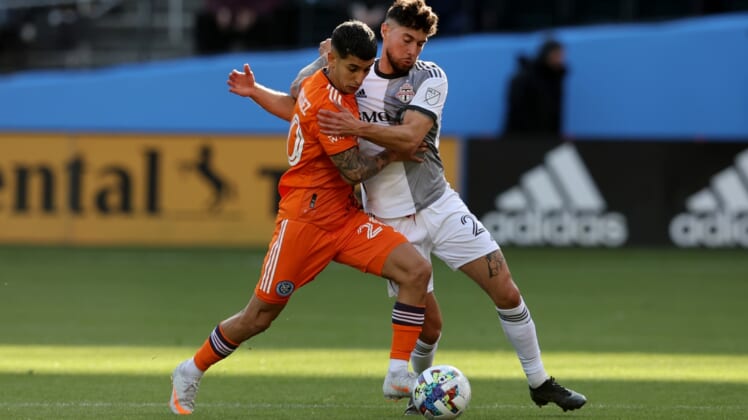 Apr 24, 2022; New York, NY, New York, NY, USA; New York City FC midfielder Santiago Rodriguez (20) and Toronto FC midfielder Jonathan Osorio (21) fight for the ball during the first half at Citi Field. Mandatory Credit: Brad Penner-USA TODAY Sports