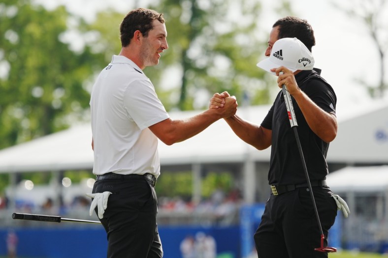 Apr 24, 2022; Avondale, Louisiana, USA; Xander Schauffele (right) embraces Patrick Cantlay (left) on the 18th green during the final round of the Zurich Classic of New Orleans golf tournament. Mandatory Credit: Andrew Wevers-USA TODAY Sports