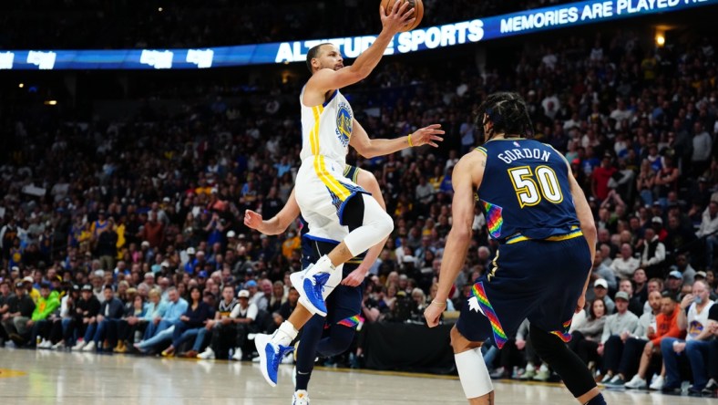 Apr 24, 2022; Denver, Colorado, USA; Golden State Warriors guard Stephen Curry (30) shoots the ball in the second half against the Denver Nuggets of the first round for the 2022 NBA playoffs at Ball Arena. Mandatory Credit: Ron Chenoy-USA TODAY Sports