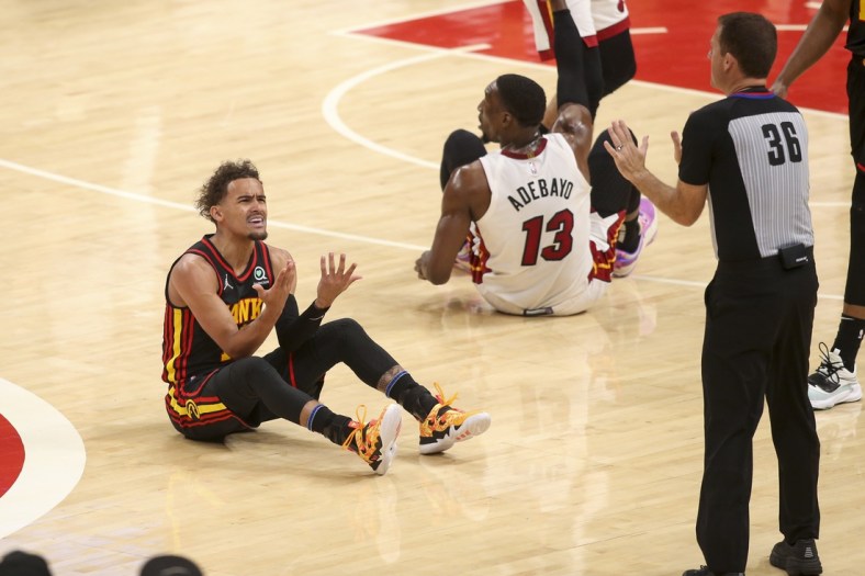 Apr 24, 2022; Atlanta, Georgia, USA; Atlanta Hawks guard Trae Young (11) reacts after being called for a foul by referee Brent Barnaky (36) against the Miami Heat in the first quarter during game four of the first round for the 2022 NBA playoffs at State Farm Arena. Mandatory Credit: Brett Davis-USA TODAY Sports