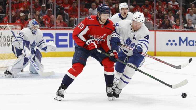 Apr 24, 2022; Washington, District of Columbia, USA; Washington Capitals center Lars Eller (20) and Toronto Maple Leafs defenseman Morgan Rielly (44) battle for the puck in the first period at Capital One Arena. Mandatory Credit: Geoff Burke-USA TODAY Sports