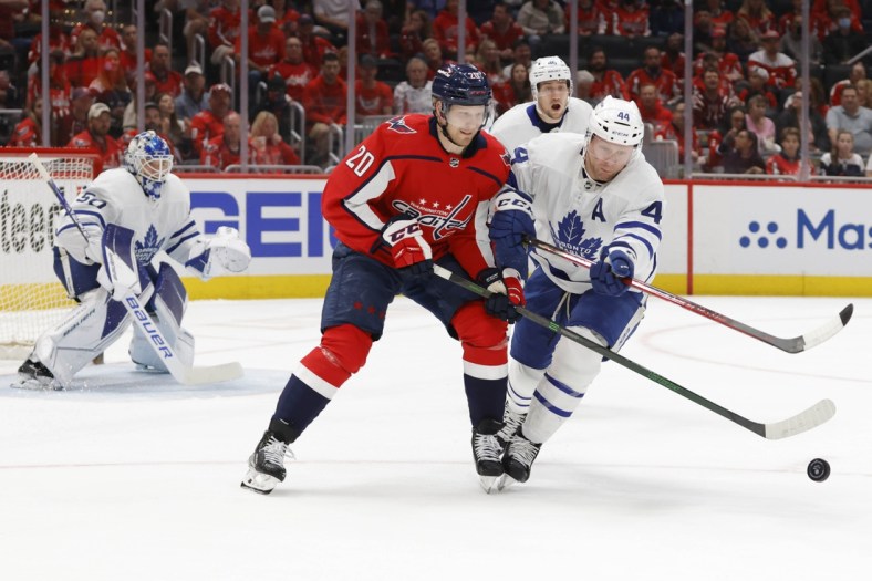 Apr 24, 2022; Washington, District of Columbia, USA; Washington Capitals center Lars Eller (20) and Toronto Maple Leafs defenseman Morgan Rielly (44) battle for the puck in the first period at Capital One Arena. Mandatory Credit: Geoff Burke-USA TODAY Sports