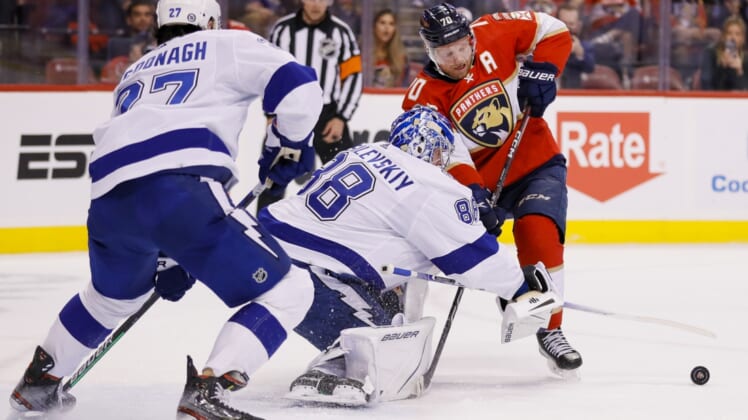 Apr 24, 2022; Sunrise, Florida, USA; Tampa Bay Lightning goaltender Andrei Vasilevskiy (88) clears the puck away from Florida Panthers right wing Patric Hornqvist (70) during the first period at FLA Live Arena. Mandatory Credit: Sam Navarro-USA TODAY Sports