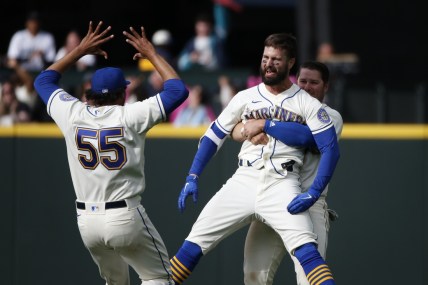 Apr 24, 2022; Seattle, Washington, USA; Seattle Mariners right fielder Jesse Winker (27) is hugged by third baseman Ty France (23, right) after hitting a walk-off RBI-single against the Kansas City Royals during the twelfth inning at T-Mobile Park. Seattle defeated Kansas City, 5-4. Mandatory Credit: Joe Nicholson-USA TODAY Sports
