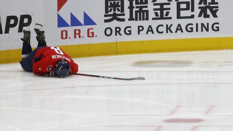 Apr 24, 2022; Washington, District of Columbia, USA; Washington Capitals left wing Alex Ovechkin (8) lies on the ice after being injured while crashing into the boards after being tripped on a breakaway attempt against the Toronto Maple Leafs in the third period at Capital One Arena. Mandatory Credit: Geoff Burke-USA TODAY Sports