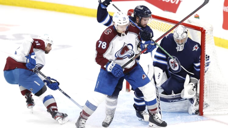 Apr 24, 2022; Winnipeg, Manitoba, CAN; Colorado Avalanche center Nico Sturm (78) is tangled up by Winnipeg Jets defenseman Josh Morrissey (44) in front of goaltender Connor Hellebuyck (37) in the third period at Canada Life Centre. Mandatory Credit: James Carey Lauder-USA TODAY Sports