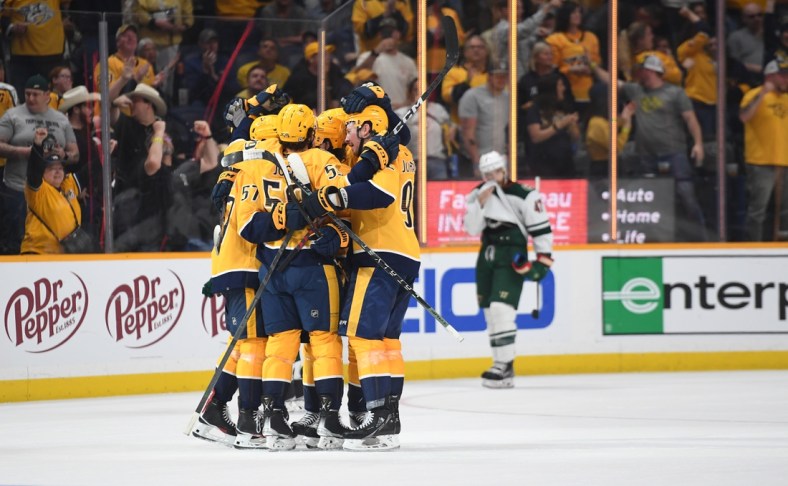Apr 24, 2022; Nashville, Tennessee, USA; Nashville Predators players celebrate after a goal by defenseman Dante Fabbro (57) during the third period against the Minnesota Wild at Bridgestone Arena. Mandatory Credit: Christopher Hanewinckel-USA TODAY Sports