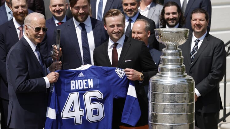 Apr 25, 2022; Washington, DC, USA; President Joe Biden (L) is presented with an honorary jersey and a silver stick by Tampa Bay Lightning defenseman Victor Hedman (M) and Lightning center Steven Stamkos (R) during a ceremony honoring the Stanley Cup champion Tampa Bay Lightning on the South Lawn at the White House Mandatory Credit: Geoff Burke-USA TODAY Sports