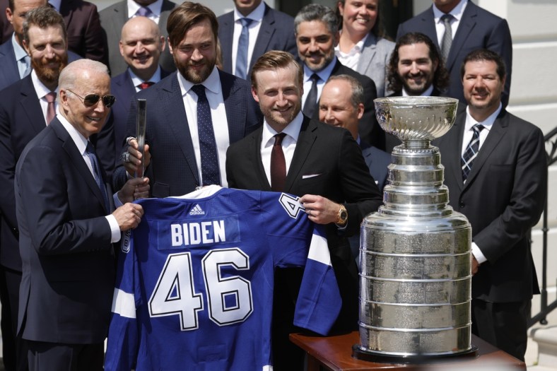Apr 25, 2022; Washington, DC, USA; President Joe Biden (L) is presented with an honorary jersey and a silver stick by Tampa Bay Lightning defenseman Victor Hedman (M) and Lightning center Steven Stamkos (R) during a ceremony honoring the Stanley Cup champion Tampa Bay Lightning on the South Lawn at the White House Mandatory Credit: Geoff Burke-USA TODAY Sports