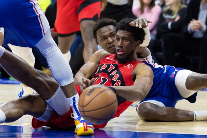 Apr 25, 2022; Philadelphia, Pennsylvania, USA; Toronto Raptors forward Thaddeus Young (21) passes the ball from the floor past Philadelphia 76ers forward Paul Reed (44) during the second quarter in game five of the first round for the 2022 NBA playoffs at Wells Fargo Center. Mandatory Credit: Bill Streicher-USA TODAY Sports