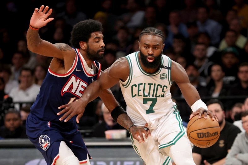 Apr 25, 2022; Brooklyn, New York, USA; Boston Celtics guard Jaylen Brown (7) controls the ball against Brooklyn Nets guard Kyrie Irving (11) during the fourth quarter of game four of the first round of the 2022 NBA playoffs at Barclays Center. The Celtics defeated the Nets 116-112 to win the best of seven series 4-0. Mandatory Credit: Brad Penner-USA TODAY Sports