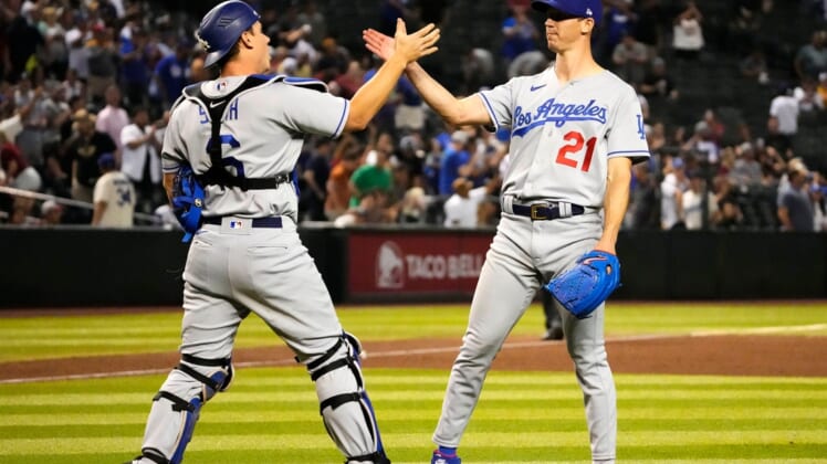 Apr 25, 2022; Phoenix, Arizona, USA; Los Angeles Dodgers catcher Will Smith (16) high-fives starting pitcher Walker Buehler (21) after throwing a three-hit complete game, beating the Arizona Diamondbacks 4-0 at Chase Field. Mandatory Credit: Rob Schumacher-Arizona RepublicMlb Los Angeles Dodgers At Arizona Diamondbacks
