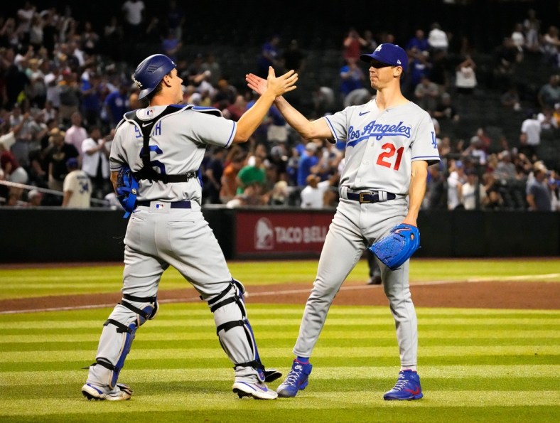 Apr 25, 2022; Phoenix, Arizona, USA; Los Angeles Dodgers catcher Will Smith (16) high-fives starting pitcher Walker Buehler (21) after throwing a three-hit complete game, beating the Arizona Diamondbacks 4-0 at Chase Field. Mandatory Credit: Rob Schumacher-Arizona Republic

Mlb Los Angeles Dodgers At Arizona Diamondbacks