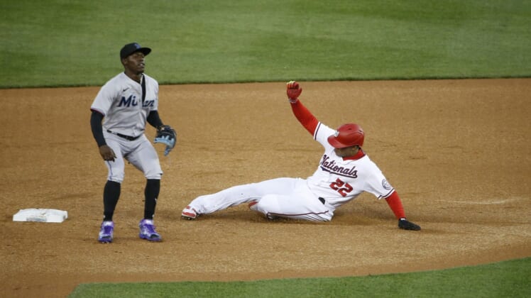 Apr 26, 2022; Washington, District of Columbia, USA; Washington Nationals right fielder Juan Soto (22) steals second base in front of Miami Marlins second baseman Jazz Chisholm Jr. (2) during the first inning against at Nationals Park. Mandatory Credit: Amber Searls-USA TODAY Sports