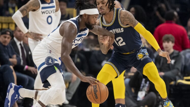 Apr 26, 2022; Memphis, Tennessee, USA; Memphis Grizzlies guard Ja Morant (12) guards Minnesota Timberwolves guard Patrick Beverley (22) during the first half of game five of the first round for the 2022 NBA playoffs at FedExForum. Mandatory Credit: Christine Tannous-USA TODAY Sports