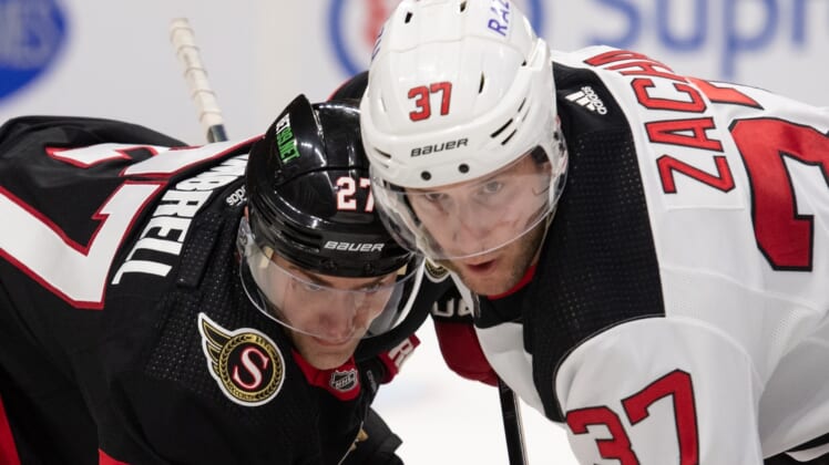 Apr 26, 2022; Ottawa, Ontario, CAN; Ottawa Senators center Dylan Gambrell (27) faces off against New Jersey Devils center Pavel Zacha (37) in the first period at the Canadian Tire Centre. Mandatory Credit: Marc DesRosiers-USA TODAY Sports