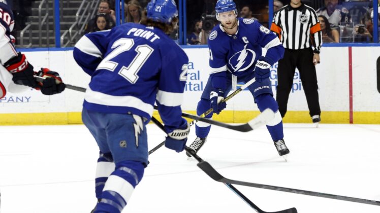 Apr 26, 2022; Tampa, Florida, USA; Tampa Bay Lightning center Steven Stamkos (91) passes the puck to center Brayden Point (21) against the Columbus Blue Jackets during the first period at Amalie Arena. Mandatory Credit: Kim Klement-USA TODAY Sports