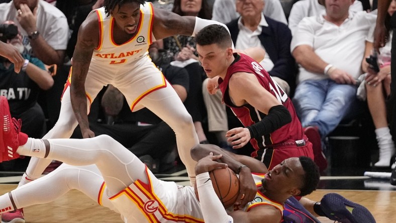 Apr 26, 2022; Miami, Florida, USA; Atlanta Hawks forward Onyeka Okongwu (17) battles Miami Heat guard Tyler Herro (14) for control of a loose ball during the first half in game five of the first round for the 2022 NBA playoffs at FTX Arena. Mandatory Credit: Jasen Vinlove-USA TODAY Sports
