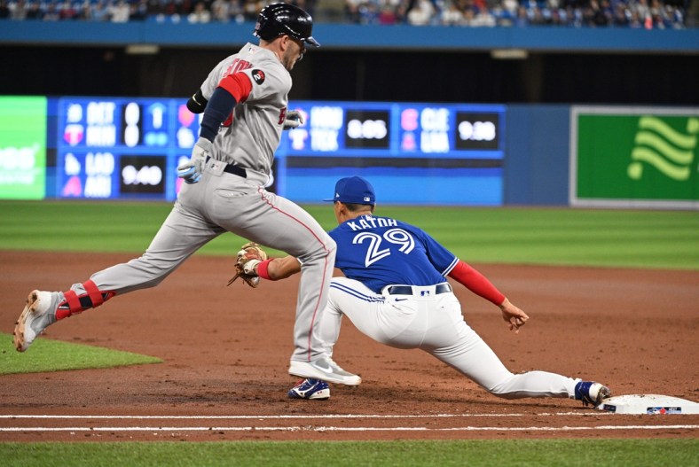 Apr 26, 2022; Toronto, Ontario, CAN; Boston Red Sox second baseman Trevor Story (10) is forced out at first base by Toronto Blue Jays first Gosuke Katoh (29) in the third inning at Rogers Centre. Mandatory Credit: Dan Hamilton-USA TODAY Sports