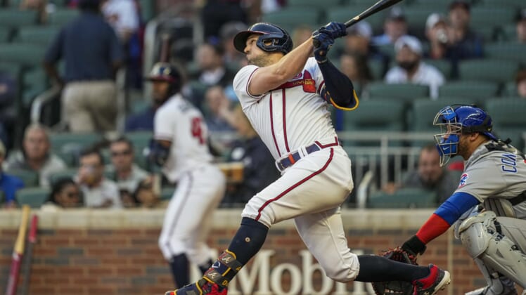 Apr 26, 2022; Cumberland, Georgia, USA; Atlanta Braves center fielder Adam Duvall (14) drives in a run with a sacrifice fly ball against the Chicago Cubs during the second inning at Truist Park. Mandatory Credit: Dale Zanine-USA TODAY Sports