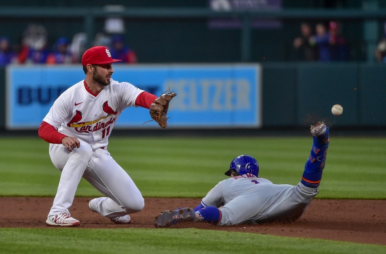 Apr 26, 2022; St. Louis, Missouri, USA;  St. Louis Cardinals shortstop Paul DeJong (11) is unable to catch the throw after the ball hit off New York Mets second baseman Jeff McNeil (1) as he slides in for a double during the third inning at Busch Stadium. Mandatory Credit: Jeff Curry-USA TODAY Sports
