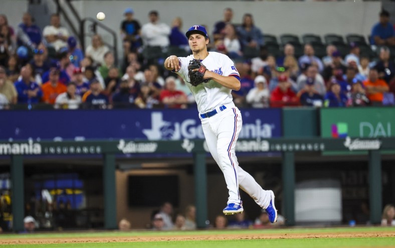 Apr 26, 2022; Arlington, Texas, USA;  Texas Rangers shortstop Corey Seager (5) throws to first base for an out during the sixth inning against the Houston Astros at Globe Life Field. Mandatory Credit: Kevin Jairaj-USA TODAY Sports