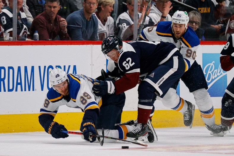 Apr 26, 2022; Denver, Colorado, USA; St. Louis Blues left wing Pavel Buchnevich (89) is pulled down by Colorado Avalanche left wing Artturi Lehkonen (62) as center Ryan O'Reilly (90) defends in the first period at Ball Arena. Mandatory Credit: Isaiah J. Downing-USA TODAY Sports