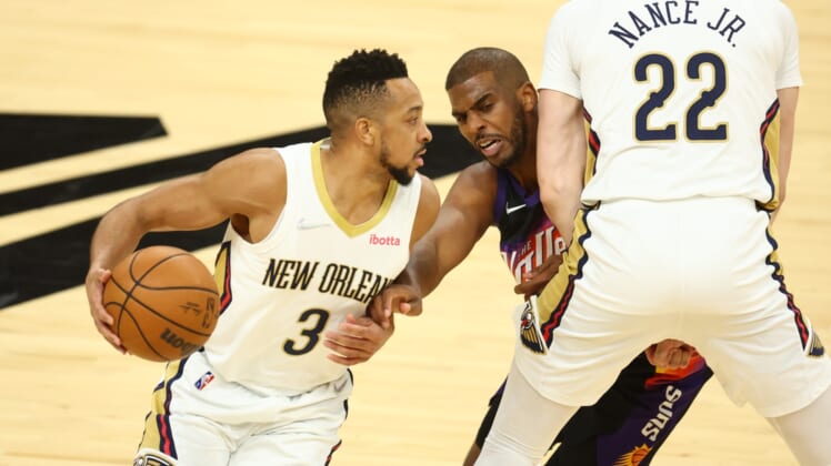 Apr 26, 2022; Phoenix, Arizona, USA; New Orleans Pelicans guard CJ McCollum (left) moves the ball against Phoenix Suns guard Chris Paul in the first half during game five of the first round for the 2022 NBA playoffs at Footprint Center. Mandatory Credit: Mark J. Rebilas-USA TODAY Sports