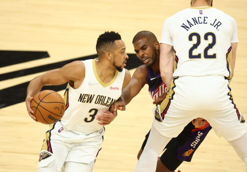 Apr 26, 2022; Phoenix, Arizona, USA; New Orleans Pelicans guard CJ McCollum (left) moves the ball against Phoenix Suns guard Chris Paul in the first half during game five of the first round for the 2022 NBA playoffs at Footprint Center. Mandatory Credit: Mark J. Rebilas-USA TODAY Sports
