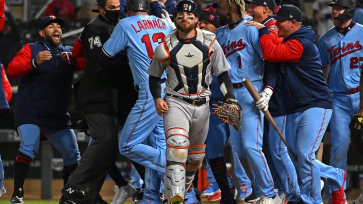 Apr 26, 2022; Minneapolis, Minnesota, USA; Detroit Tigers catcher Eric Haase (13) walks off the field as the Minnesota Twins celebrate their walk-off win as a result of his throwing error during the ninth inning at Target Field. Mandatory Credit: Nick Wosika-USA TODAY Sports
