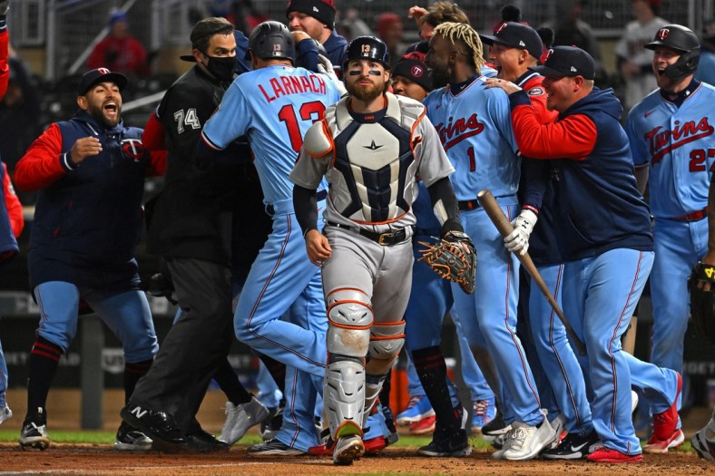 Apr 26, 2022; Minneapolis, Minnesota, USA; Detroit Tigers catcher Eric Haase (13) walks off the field as the Minnesota Twins celebrate their walk-off win as a result of his throwing error during the ninth inning at Target Field. Mandatory Credit: Nick Wosika-USA TODAY Sports