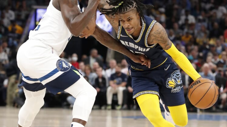 Apr 26, 2022; Memphis, Tennessee, USA; Minnesota Timberwolves guard Patrick Beverley (22) guards Memphis Grizzlies guard Ja Morant (12) during the first half of game five of the first round for the 2022 NBA playoffs at FedExForum. Mandatory Credit: Christine Tannous-USA TODAY Sports