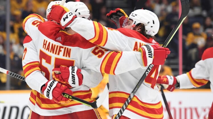 Apr 26, 2022; Nashville, Tennessee, USA; Calgary Flames players celebrate after a goal by defenseman Noah Hanifin (55) during the third period against the Nashville Predators at Bridgestone Arena. Mandatory Credit: Christopher Hanewinckel-USA TODAY Sports