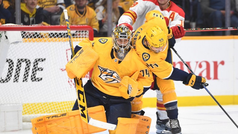 Apr 26, 2022; Nashville, Tennessee, USA; Nashville Predators goaltender Juuse Saros (74) makes a save during the third period against the Calgary Flames at Bridgestone Arena. Mandatory Credit: Christopher Hanewinckel-USA TODAY Sports