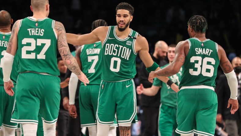 Apr 23, 2022; Brooklyn, New York, USA;  Boston Celtics forward Jayson Tatum (0) with center Daniel Theis (27) and guard Marcus Smart (36) at Barclays Center. Mandatory Credit: Wendell Cruz-USA TODAY Sports