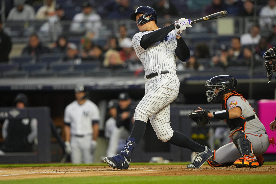 Apr 27, 2022; Bronx, New York, USA; New York Yankees center fielder Aaron Judge (99) hits a single against the Baltimore Orioles during the first inning at Yankee Stadium. Mandatory Credit: Gregory Fisher-USA TODAY Sports