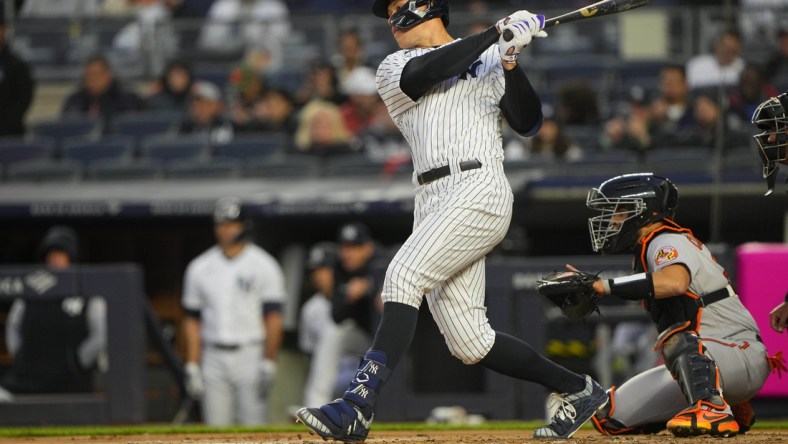 Apr 27, 2022; Bronx, New York, USA; New York Yankees center fielder Aaron Judge (99) hits a single against the Baltimore Orioles during the first inning at Yankee Stadium. Mandatory Credit: Gregory Fisher-USA TODAY Sports