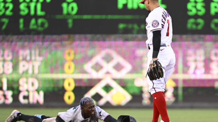 Apr 27, 2022; Washington, District of Columbia, USA; Miami Marlins second baseman Jazz Chisholm Jr. (2) reacts after being caught stealing as Washington Nationals second baseman Cesar Hernandez (1) looks on during the first inning at Nationals Park. Mandatory Credit: Brad Mills-USA TODAY Sports