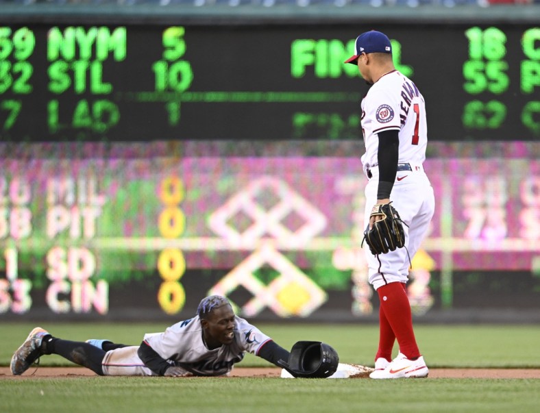 Apr 27, 2022; Washington, District of Columbia, USA; Miami Marlins second baseman Jazz Chisholm Jr. (2) reacts after being caught stealing as Washington Nationals second baseman Cesar Hernandez (1) looks on during the first inning at Nationals Park. Mandatory Credit: Brad Mills-USA TODAY Sports