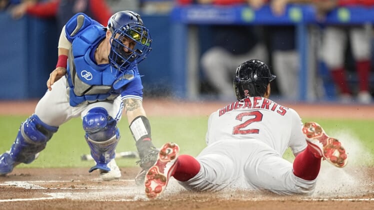 Apr 27, 2022; Toronto, Ontario, CAN; Boston Red Sox shortstop Xander Bogaerts (2) beats the tag by Toronto Blue Jays catcher Tyler Heineman (22) to score on a double hit by Boston Red Sox third baseman Rafael Devers (not pictured) during the first inning at Rogers Centre. Mandatory Credit: John E. Sokolowski-USA TODAY Sports
