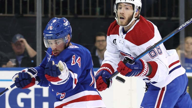 Apr 27, 2022; New York, New York, USA; New York Rangers center Greg McKegg (14) and Montreal Canadiens center Mike Hoffman (68) fight for the puck during the first period at Madison Square Garden. Mandatory Credit: Brad Penner-USA TODAY Sports