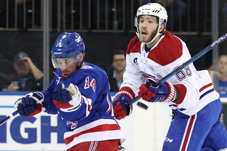 Apr 27, 2022; New York, New York, USA; New York Rangers center Greg McKegg (14) and Montreal Canadiens center Mike Hoffman (68) fight for the puck during the first period at Madison Square Garden. Mandatory Credit: Brad Penner-USA TODAY Sports