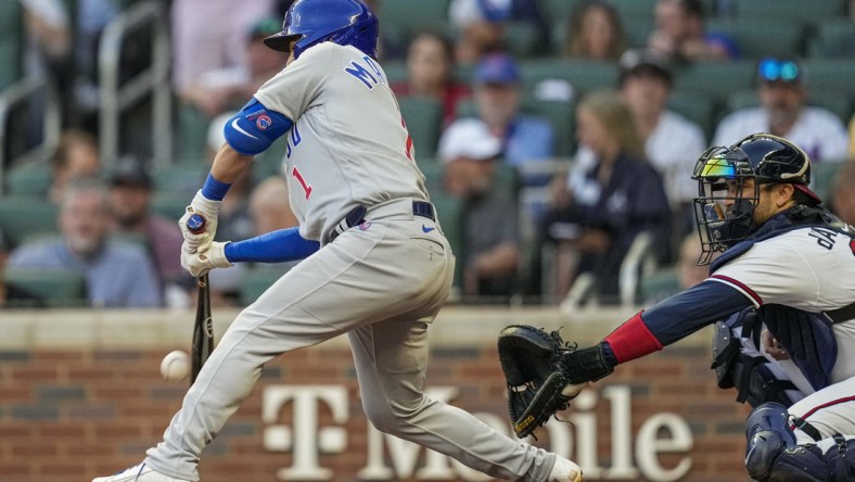 Apr 27, 2022; Cumberland, Georgia, USA; Chicago Cubs second baseman Nick Madrigal (1) hits into a fielders choice to score a run against the Atlanta Braves during the second inning at Truist Park. Mandatory Credit: Dale Zanine-USA TODAY Sports