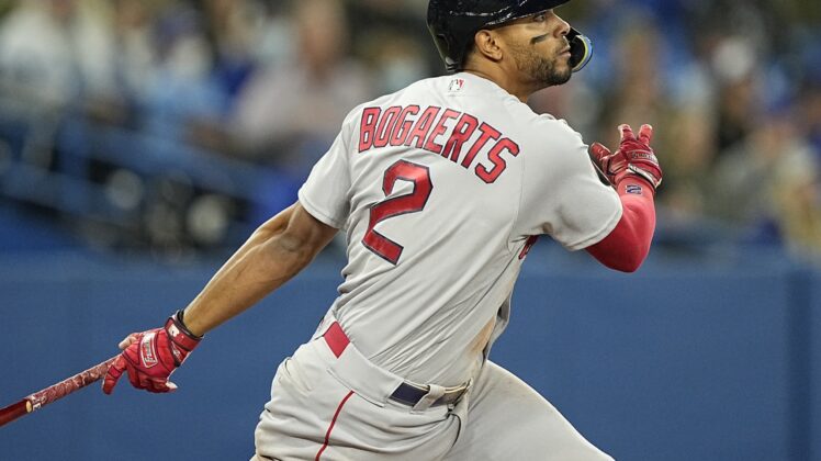 Apr 27, 2022; Toronto, Ontario, CAN; Boston Red Sox shortstop Xander Bogaerts (2) hits a single against the Toronto Blue Jays during the sixth inning at Rogers Centre. Mandatory Credit: John E. Sokolowski-USA TODAY Sports